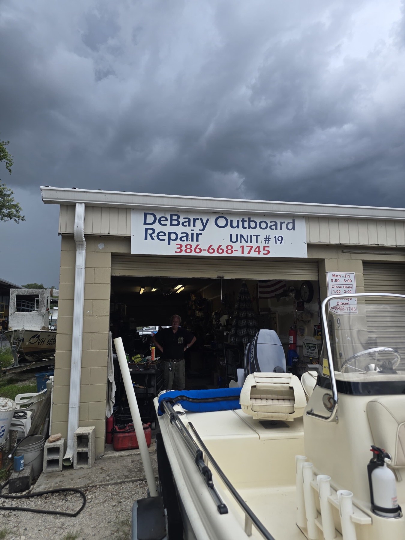Boat in for repair inside the DeBary Outboard Repair shop
